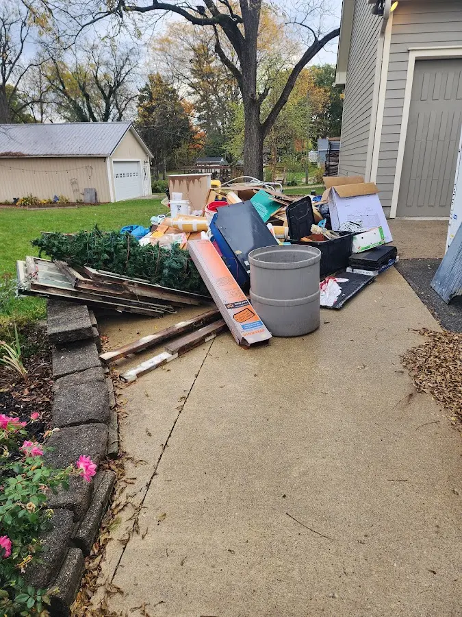 Dumpster being loaded with debris for 12 Yard Dumpster Rental in Senatobia